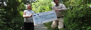 Anna Harvey and McNabb Laurie holding the big SGS cheque